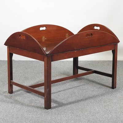 Lot 442 - A mahogany coffee table, in the form of a...