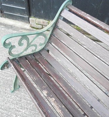 Lot 409 - A slatted garden bench, with green painted...