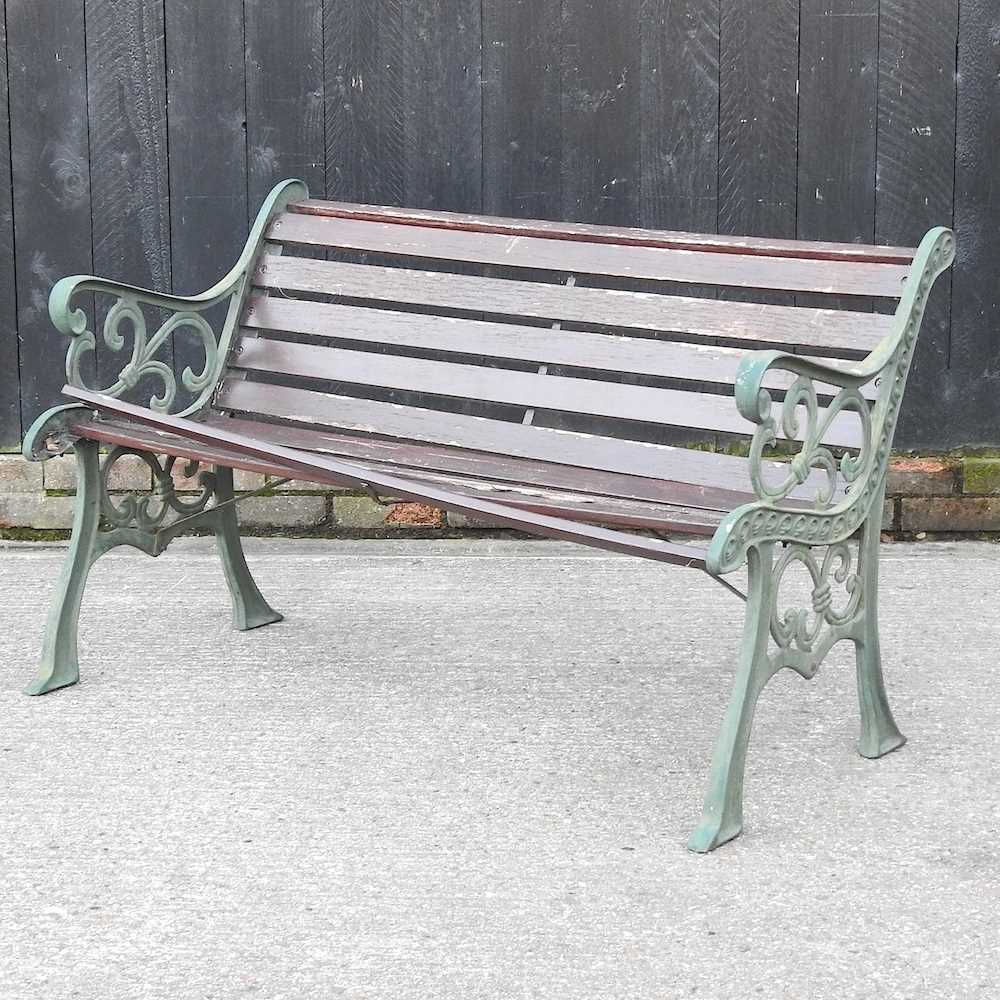 Lot 409 - A slatted garden bench, with green painted...