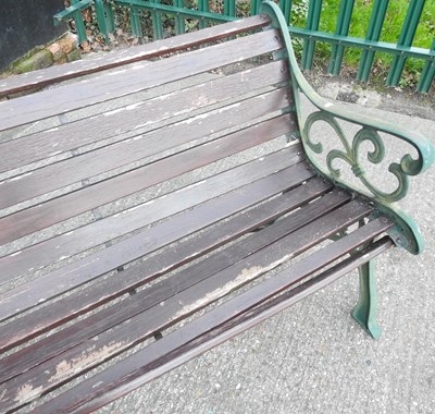 Lot 409 - A slatted garden bench, with green painted...