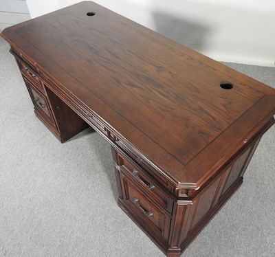 Lot 180 - A modern oak pedestal desk, on a plinth base