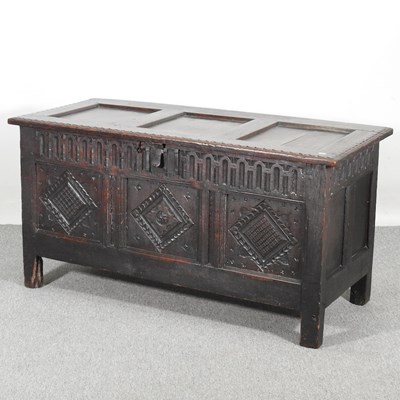 Lot 162 - An 18th century carved oak coffer, with a...