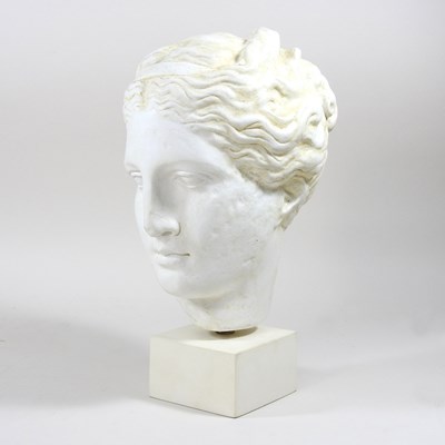 Lot 498 - A plaster head of Hygieia, on a plinth base,...