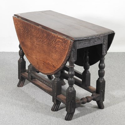 Lot 465 - An early 20th century carved oak gateleg table