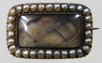 Lot 31 - A George III seed pearl mourning brooch, inset...