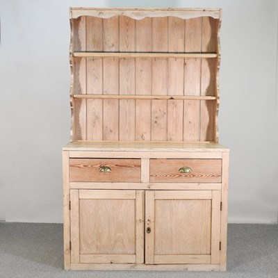 Lot 115 - An antique pine dresser, with a boarded back