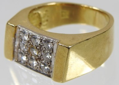 Lot 55 - An 18 carat gold nine stone pave set diamond...