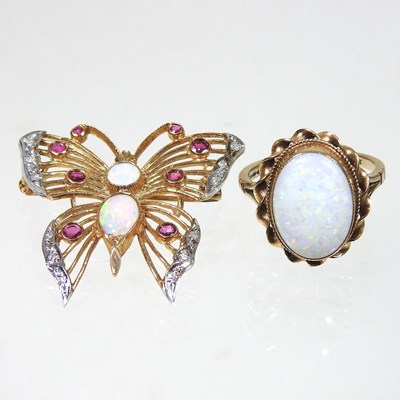 Lot 65 - A gold and opal cabochon ring, with a twisted...