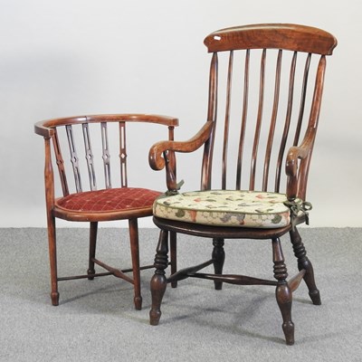 Lot 563 - An early 20th century elm seated spindle back armchair