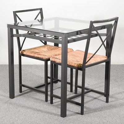 Lot 369 - A metal dining table, with a glass top,...
