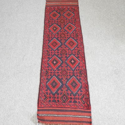 Lot 399 - A Persian runner, with two rows of diamonds,...