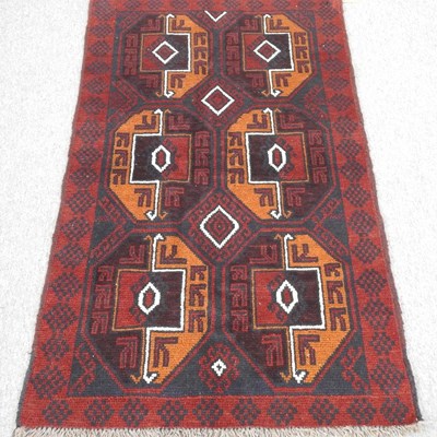 Lot 241 - A baluchi rug, with two rows of medallions, on...