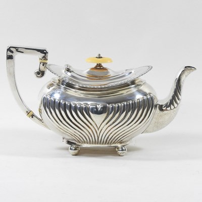 Lot 122 - An Edwardian silver teapot, with a half...