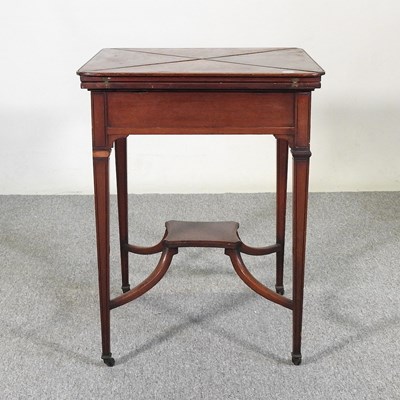Lot 544 - An Edwardian mahogany envelope card table, on...