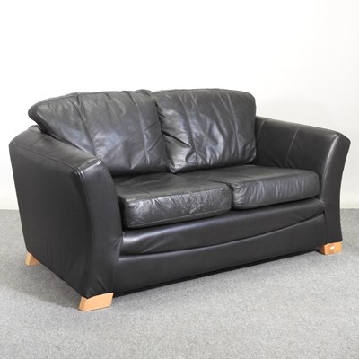Lot 469 - A modern black upholstered two seater sofa