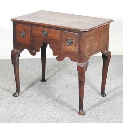 Lot 237 - An 18th century oak lowboy, containing three...
