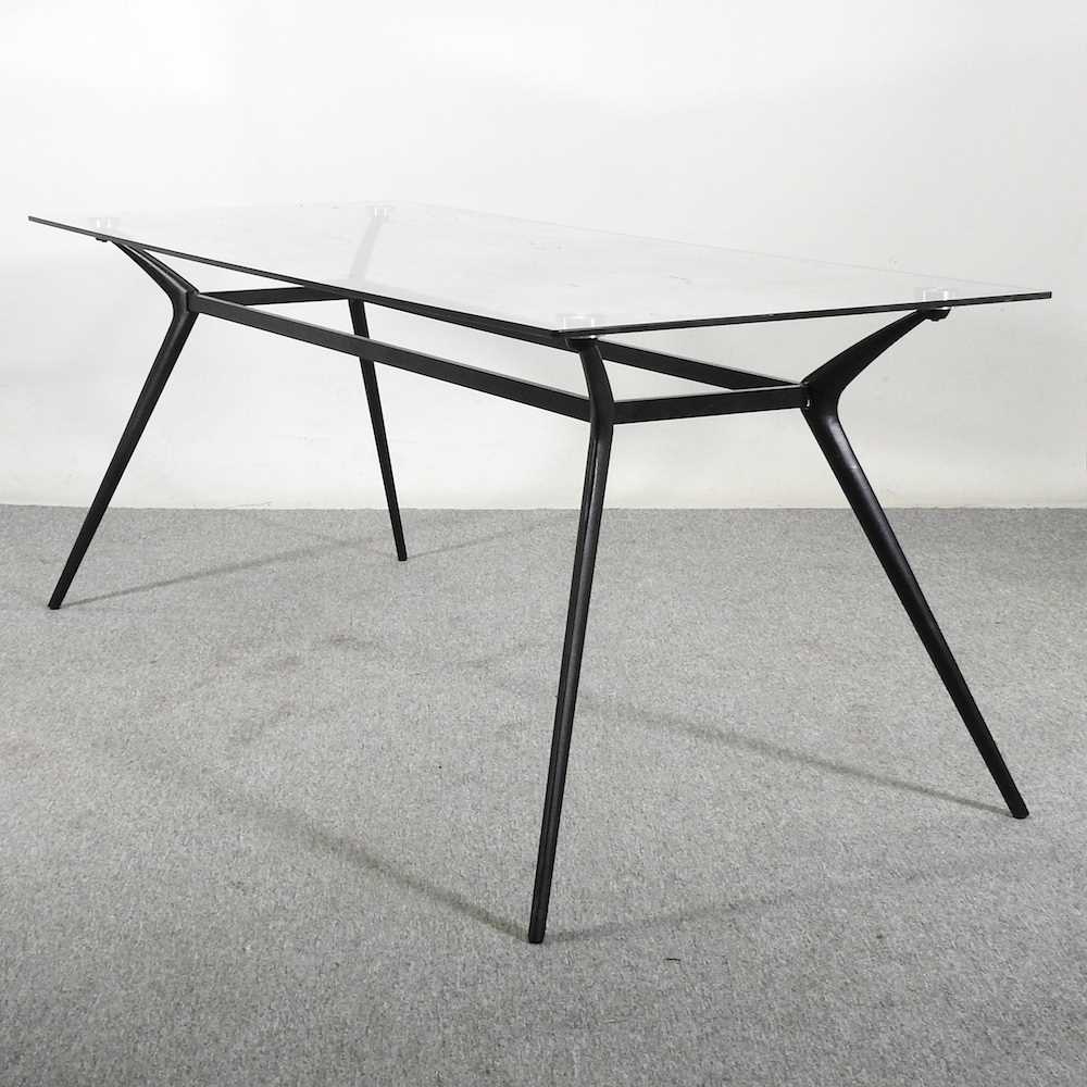 Lot 504 - A contemporary dining table, with a glass top,...