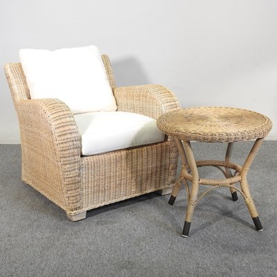Lot 259 - A wicker armchair, with cream cushions,...