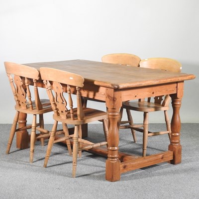 Lot 299 - A pine dining table, together with a set of...