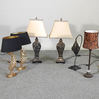 Lot 340 - A pair of gilt table lamps, with black shades,...