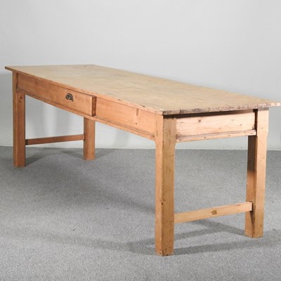 Lot 230 - A large antique pine kitchen table, containing...