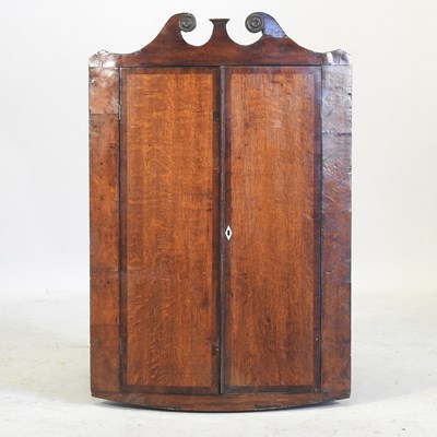 Lot 318 - A George III oak and mahogany crossbanded hanging corner cabinet
