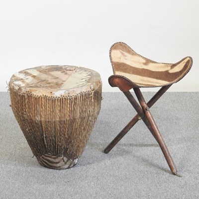 Lot 497 - An African hide drum, 38cm wide, together with...