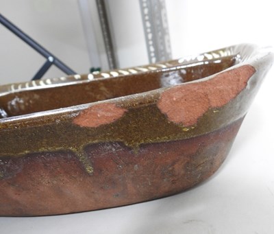 Lot 6 - A slipware baking tray, 39cm wide, together...
