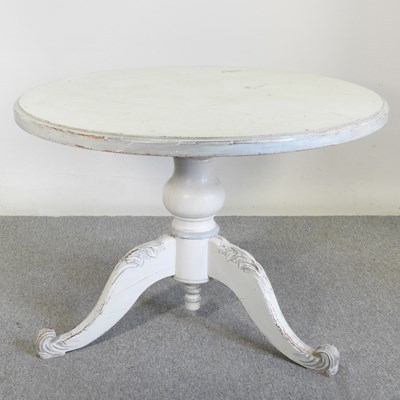 Lot 156 - A rustic cream painted pine circular dining...