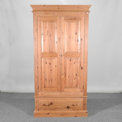 Lot 314 - A modern pine double wardrobe, with a drawer...