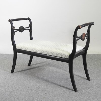 Lot 420 - A 19th century ebonised window seat, with a...
