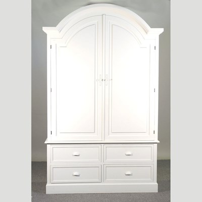 Lot 150 - A white painted armoire, fitted with shelves,...
