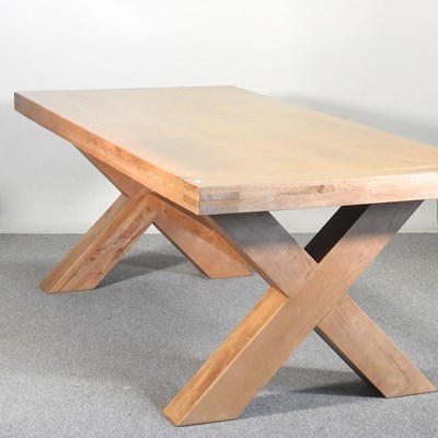 Lot 86 - A modern light oak dining table, on an x-frame...
