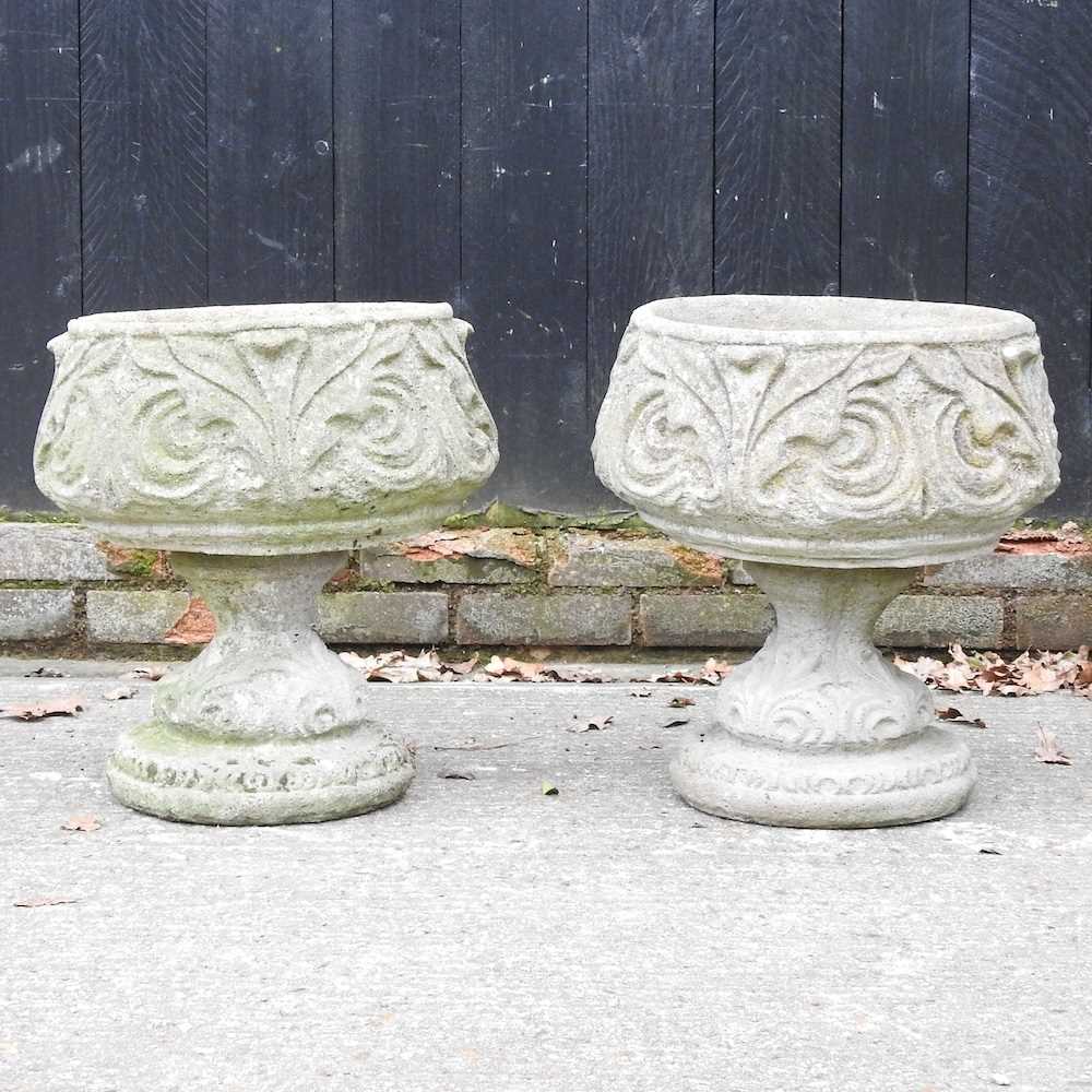Lot 23 - A pair of cast stone garden planters, each on...