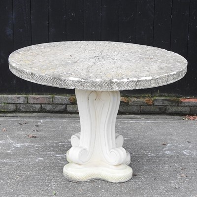Lot 47 - A cast stone circular garden dining table, on...