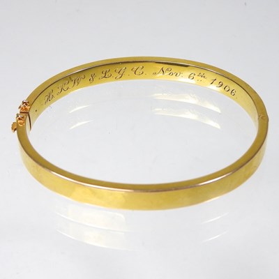 Lot 1 - An Edwardian 14 carat gold bangle, of hinged...