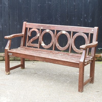 Lot 391 - A slatted wooden Millenium 2000 garden bench,...