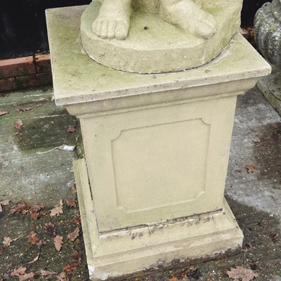 Lot 1 - A cast stone garden statue figure of a cherub,...