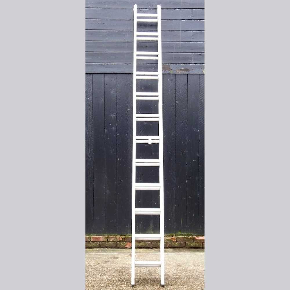 Lot 257 - An aluminium extending ladder in two sections,...