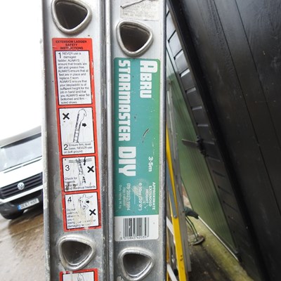 Lot 257 - An aluminium extending ladder in two sections,...