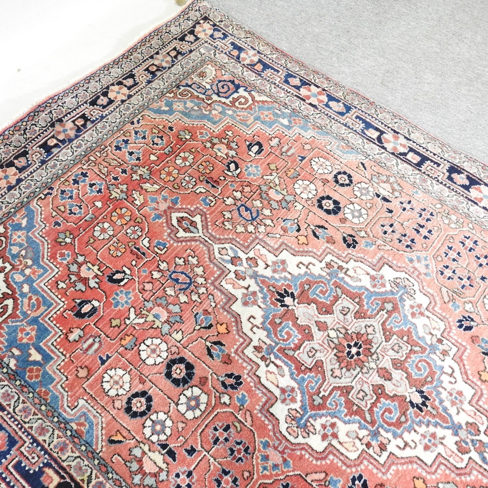 Lot 279 - A Persian rug, with a large central