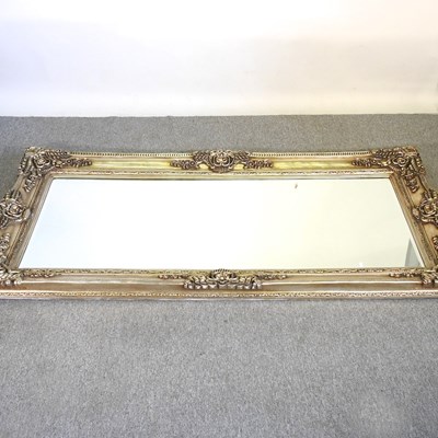 Lot 218 - A large silver painted wall mirror, with a...