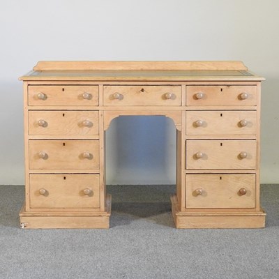 Lot 81 - An antique pine pedestal desk, with a green...