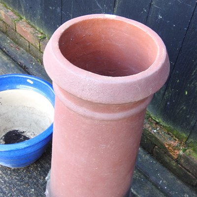 Lot 38 - A terracotta chimney pot, 75cm high, together...