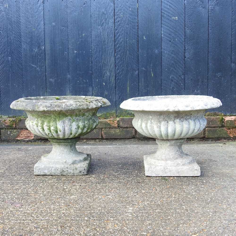 Lot 43 - A pair of small cast stone garden urns, on...