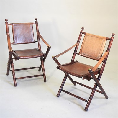 Lot 375 - A pair of folding leather and simulated bamboo safari chairs