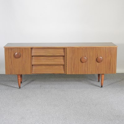 Lot 518 - A 1970's laminated sideboard, on tapered legs