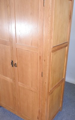 Lot 337 - A modern light oak double wardrobe