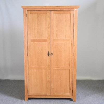 Lot 337 - A modern light oak double wardrobe