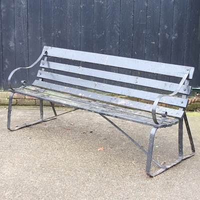 Lot 62 - A black painted wooden garden bench, with iron...